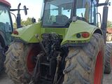 two tractors that are parked next to each other in the dirt