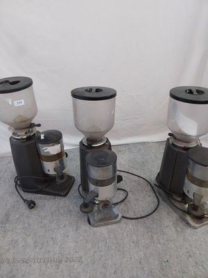 three coffee grinders sitting on the floor next to each other