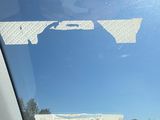 a reflection of a building in the window of a car