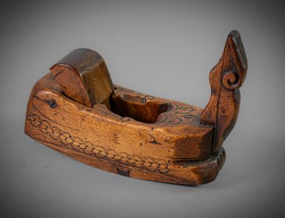 an old wooden plane with a wooden handle on a gray surface