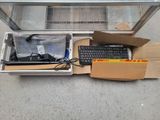 a box with a keyboard, mouse, and other items in it