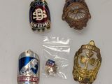 some badges are laying on top of a white surface