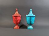 two vases sitting next to each other on a gray surface