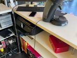 a desk with two computers and a printer on it