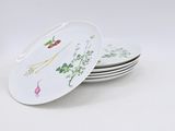 several plates with different types of vegetables on them on a white surface