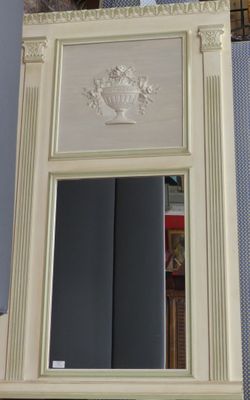 a mirror that is sitting on a shelf in a room