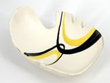 a white bowl with a yellow and black design on it