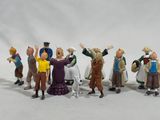 many figurines of people standing in a line