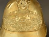 a brass bell with a picture of a train on it