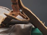 a close up of a leather bag with a pair of pliers on it