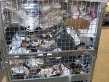 a metal cage filled with lots of stuffed animals