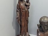 statue of a woman holding a child in her arms next to a statue of a lion