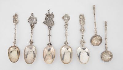 several spoons and spoon spoons are lined up on a white surface