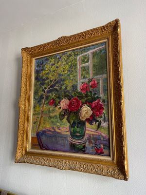 a painting on the wall of a room with a vase of flowers