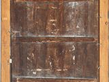 an old wooden door with a metal handle and a wooden frame