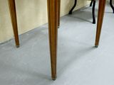 a small wooden table with a drawer on top of it