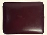the brown leather wallet is open on a white surface