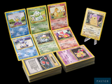 a lot of pokemon cards sitting on top of each other