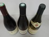 three bottles of wine sitting next to each other on a counter