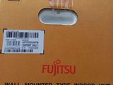 a cardboard box with a sticker on it sitting on top of a pile of boxes