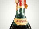 a close up of a bottle of olive wine on a white background