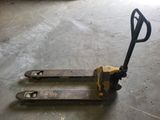 a forklift sitting on the floor in a garage