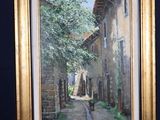 a picture of a painting on a easel with a picture of a street
