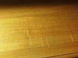 a close up of a wooden table with a clock on it