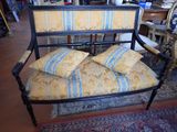 a bench with pillows on top of it in a room