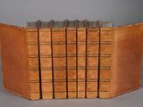 several old books are stacked on top of each other on a table