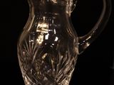 a glass pitcher that is sitting on a table