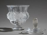 a glass cup and a spoon sitting on a table