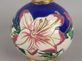 un vase bleu orné d'une fleur blanche et rose