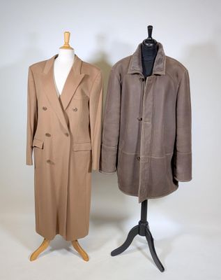 two coats on a mannequin stand on a white background