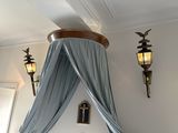 a bed with a canopy over it in a room