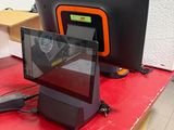 a red table with a monitor and a laptop on it
