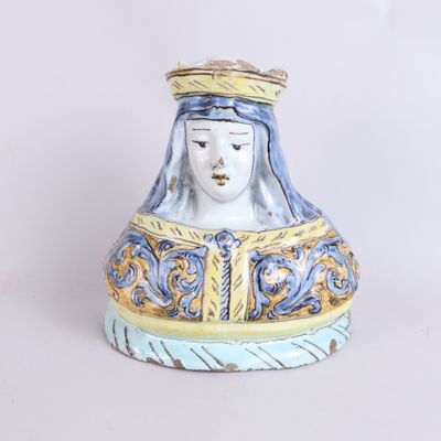 a ceramic figurine of a woman with a crown on her head