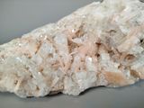 a close up of a piece of rock with white crystals on it