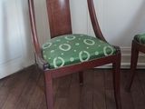 two chairs in the corner of a room with wood flooring