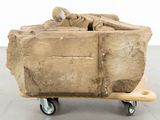 a large piece of stone on a dolly in the middle of a room