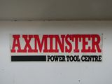 a sign on the side of a building that says axminister power tool centre