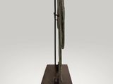 bronze sculpture of a bird on a stand on a white background