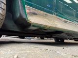a close up view of a green car parked on the side of the road