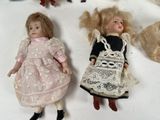 two dolls that are laying next to each other on a table
