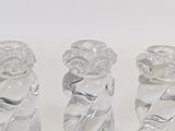 three glass figurines that are sitting on a table