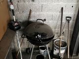 a black grill sitting in the corner of a room