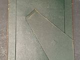 a picture of a piece of metal with a piece of paper on it