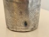 a silver cup that is sitting on a table