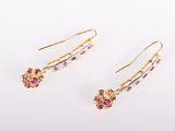 a pair of pink sapphire and diamond earrings on a white background