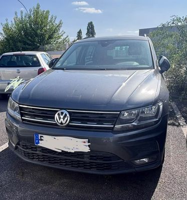 two cars parked in a parking lot next to each other